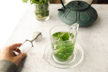 Tea with fresh mint leaves. Mint infusion helps with digestive problems