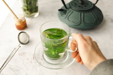 Tea with fresh mint leaves. Mint infusion helps with digestive problems