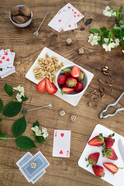 Flat Lay Composition Strawberries Nuts Playing Cards Wooden Table — Stock Photo, Image