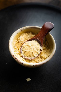 Bir kase yakın çekim ve besin maya ile ahşap kaşık, mükemmel vegan protein