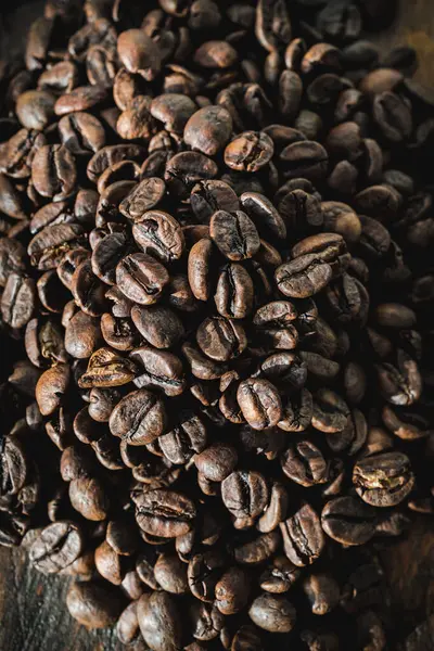 stock image A close-up of a large pile of rich, roasted coffee beans showcasing their texture and color.