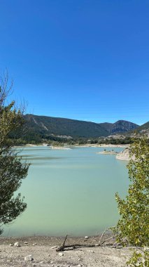 The Embalse de Arguis is a serene reservoir located on the Isuela River, within the municipality of Arguis in Huesca, Spain. clipart