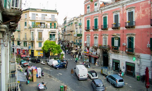 stock image April 04 2022 - Naples Italy-The crowded street one morning with lots of scooters and people walking to work past old colorful buildings