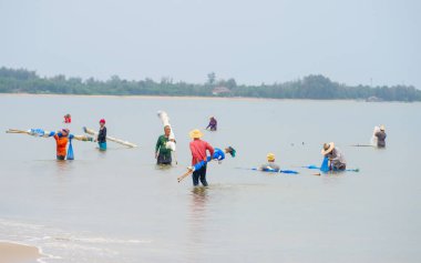 22 January 2023- Chumphon Thailand fishermen fish with nets in shallow water in the Thai sea