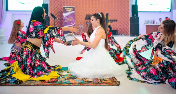 stock image June- 2023 03- Bucharest-Romania- The bride during her wedding has fun and dances with the entertainers who are dressed multicolored