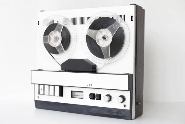old-style reel-to-reel tape recorder, selective focus, close-up on a white background