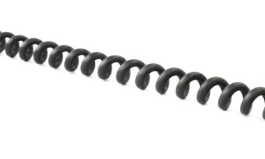 Close-up of a twisted black telephone cord on an isolated white background