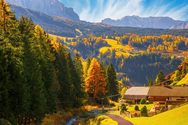 stock image Autumn scenery of Dolomite Alps. Colorful hills and rocky mountains under picturesque sky. Alpine village Santa Cristina Val Gardena. It is a famous resort in the Dolomites, Italy