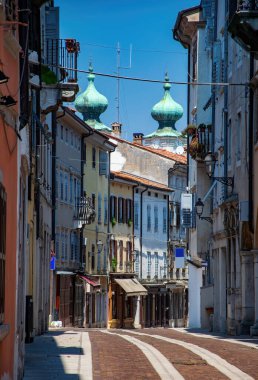 Gorizia, Friuli Venezia Giulia, İtalya 'da dar, dolambaçlı bir ortaçağ caddesi. Arka planda Aziz Ignatius Kilisesi 'nin Cupolas' ları var.