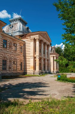 Ternopil, Ukrayna 'daki harap olmuş Koropet Sarayı' nın dış görünüşü. Neoklasik sütunlar ve kendine özgü kubbeli bir çatısı olan süslemeli cephe, parlak mavi bir gökyüzüne karşı dizilmiş.