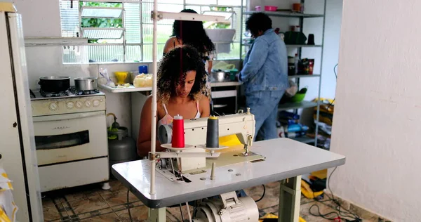 Entrepreneur black woman working from home knitting on machine