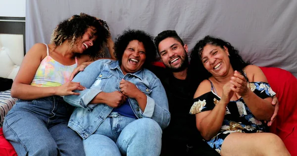 Happy Brazilian family laughing together. Casual hispanic latin people laugh, real life