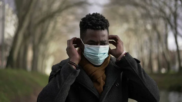 African Man Putting Covid Face Mask While Walking Pandemic Prevention — Stockfoto