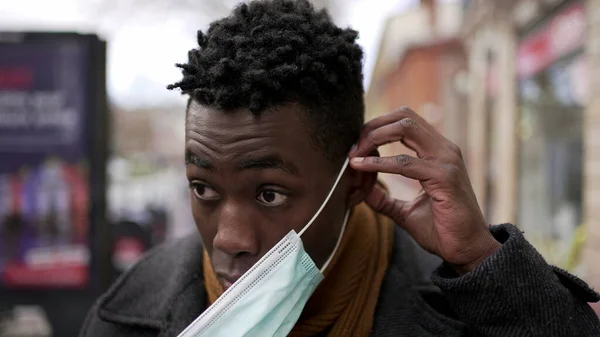 Black Man Putting Covid Face Mask While Walking City Cold — Stock Fotó