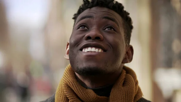 Black man looking at sky smiling with HOPE and FAITH