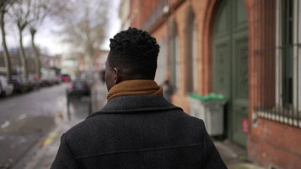 Black Man Walking Outdoors City Sidewalk Winter Back African Person — стоковое фото