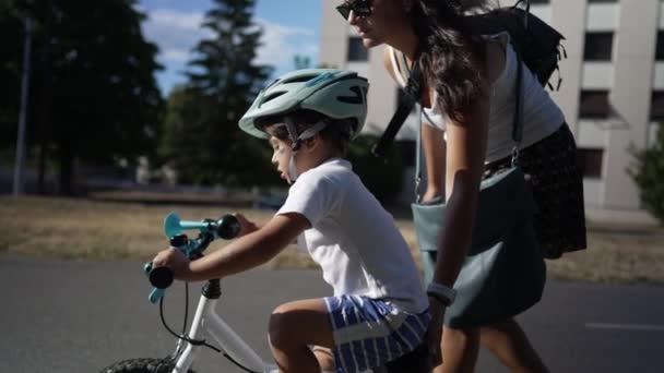 Active Small Boy Learning Ride Bicycle Wearing Helmet Mother Helping — Stock Video