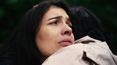 Sorrowful woman closeup face with negative emotion hugging friend