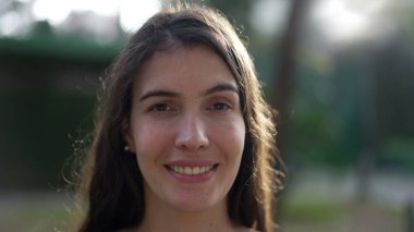 Happy woman opening eyes to camera smiling. Contemplative person with eyes closed feeling FREEDOM and meditative