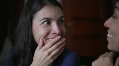 Friend telling secret to woman ear whispering. Young woman shock surprise reaction to gossip news. People sharing secrets