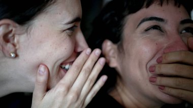 Women sharing rumor whispering SECRET to friend ear. Person reaction with SHOCK and UNBELIEF to NEWS