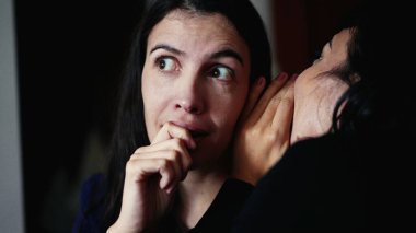 Woman reaction to SURPRISE to gossip news by female friend whispering SECRET with SHOCK. Person revealing unbelievable NEWS