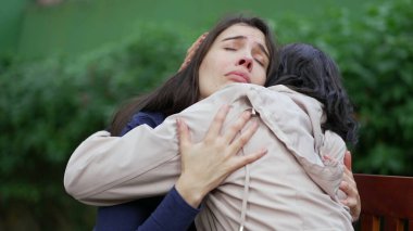 Sad woman suffering from negative emotion. Two women embracing each other with EMPATHY