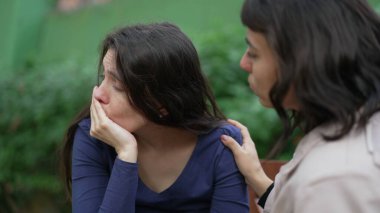 Sad woman suffering from negative emotion. Two women embracing each other with EMPATHY