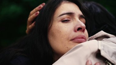 Sorrowful woman closeup face with negative emotion hugging friend