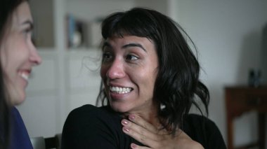 Friends sharing gossip whispering secret to woman ear telling SHOCKING news revelation. Two women sharing information