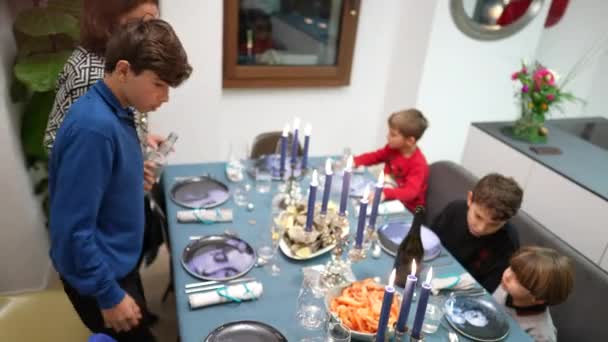 ディナーテーブルでお祝いの休日を祝うために約家族 テーブルに座って食べ物が届くのを待っている子供たち — ストック動画