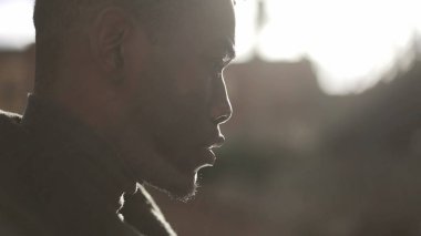 Dalgın siyah adam dışarıda yürüyor. İçsel düşünceli Afrikalı adam düşünüyor