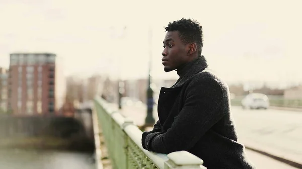 Pensive Black African Man Standing Bridge Thinking Life Looking Horizon — ストック写真