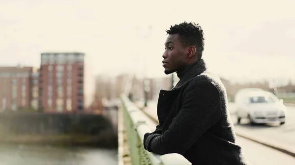 Pensive Black African Man Standing Bridge Thinking Life Looking Horizon — ストック写真