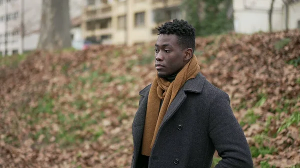 Pensive Black Man Standing Cold Winter Season Wearing Scar Coat — ストック写真