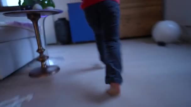 自宅のリビングルームで屋内で走る幸せな子供 近代的な家の中で子供の足のランナーを閉じます — ストック動画