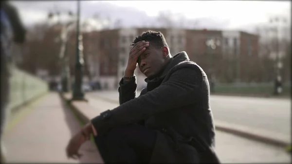 Worried Black Man Sitting Floor Street Having Problems Rubbing Face — стоковое фото