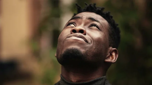 Young black man close-up face looking at sky