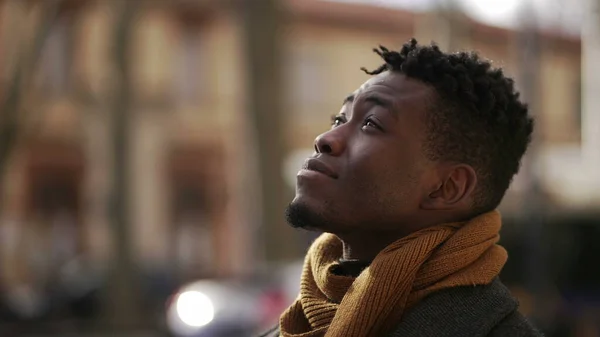 Young black male looks at sky with HOPE