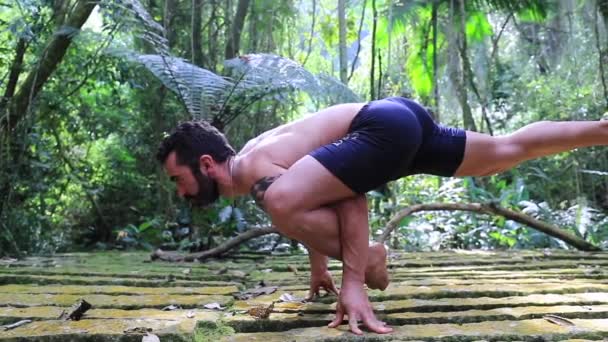 ヨガマントレーニング難しいポーズ屋外で自然の中で — ストック動画