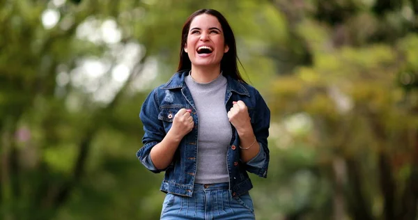 Person celebrating great news cheering. Young woman celebrating successful notification
