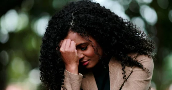 Black woman feeling regret and frustration outside