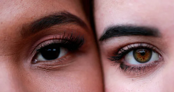 Two beautiful diverse women eyes macro close-up, diversity