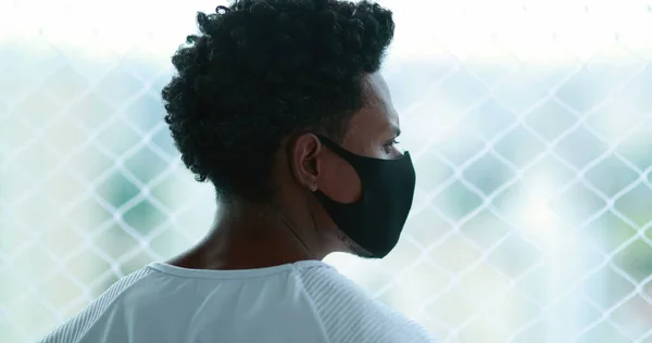 Black African Man Standing Window Looking Outdoors Wearing Epidemic Mask — Stock fotografie