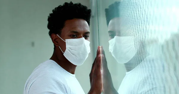 African Man Holding Window Hands Quarantine Lockdown Wearing Virus Mask — Stock Fotó