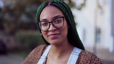 Gülümseyen Brezilyalı genç siyah bir kadının portresi örgülü saçlarıyla