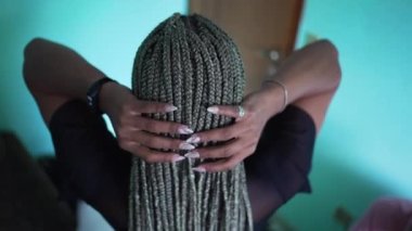 A black latina girl with box braids hairstyle
