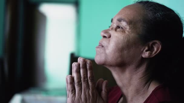 Uma Mulher Hispânica Sénior Rezar Deus Idoso Brasileiro Fechando Olhos — Vídeo de Stock