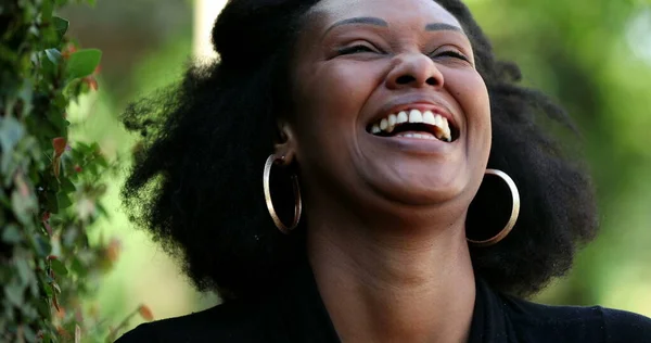 African woman laughing and smiling. Black lady authentic laugh