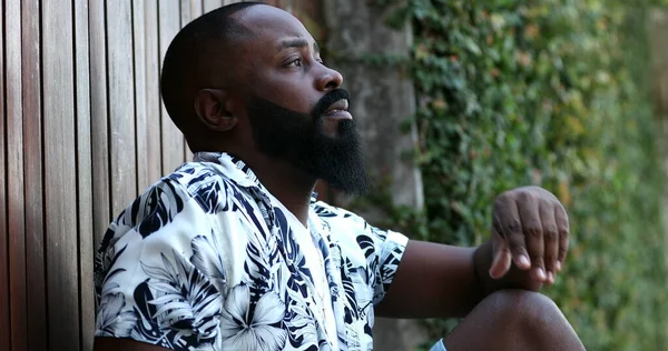 stock image Overwhelmed African man feeling anxious sitting on floor